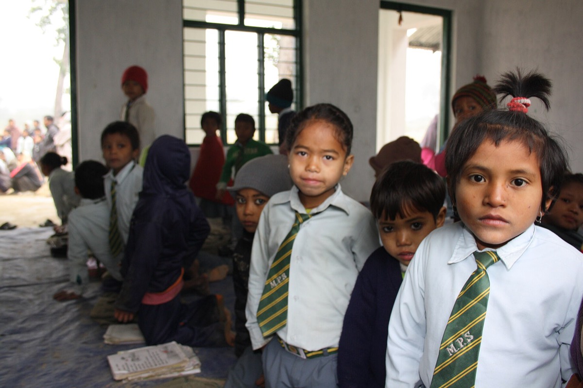 Young students in school uniforms and ties lined up at their school in Nepal
