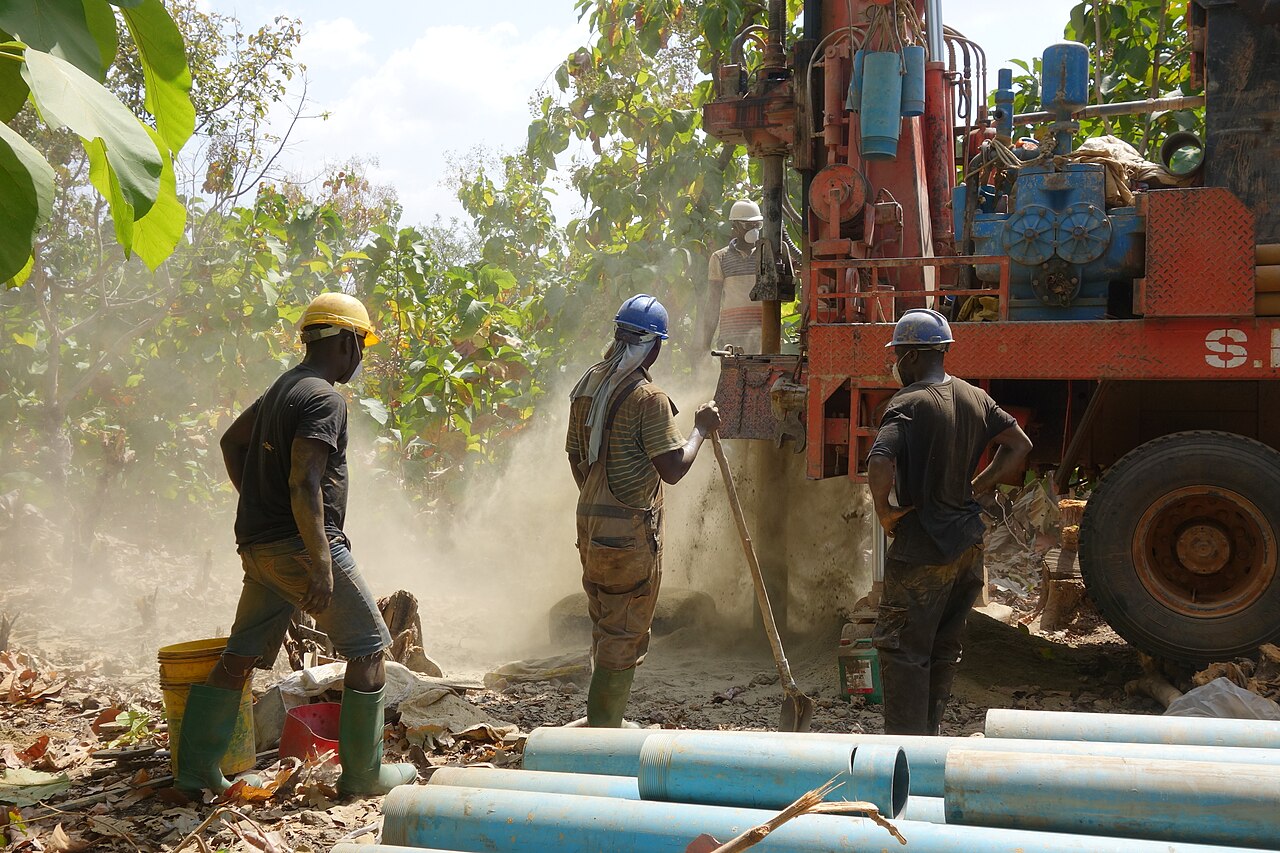 Water drilling technicians work together to drill for water in Djamde, Togo